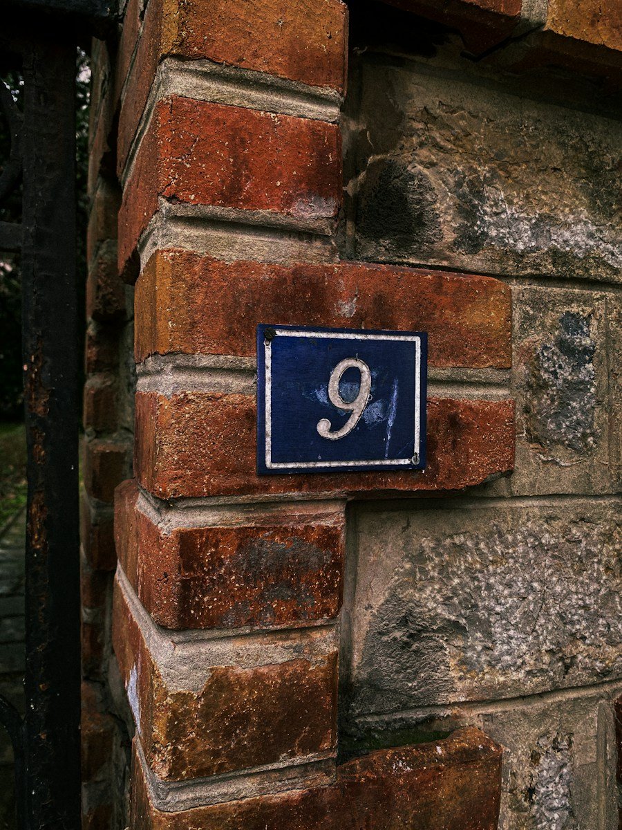 a brick wall with a blue sign on it