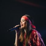 woman in red dress holding microphone