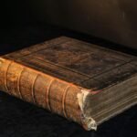 brown hardbound book on table