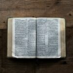 an open book sitting on top of a wooden table