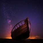 silhouette photography of sailing boat on body of water