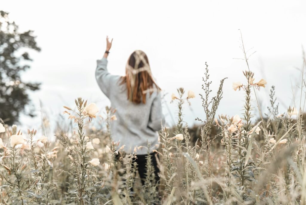 woman in white sweater standing on brown grass field during daytime - Gods Peace Is Different From The Worlds Peace