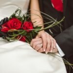 man holding red flowers