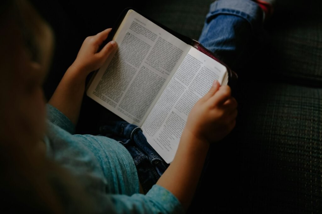 toddler girl reading a book at vehicle backseat - the Height of David in the bible