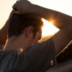 man holding his hair against sunlight