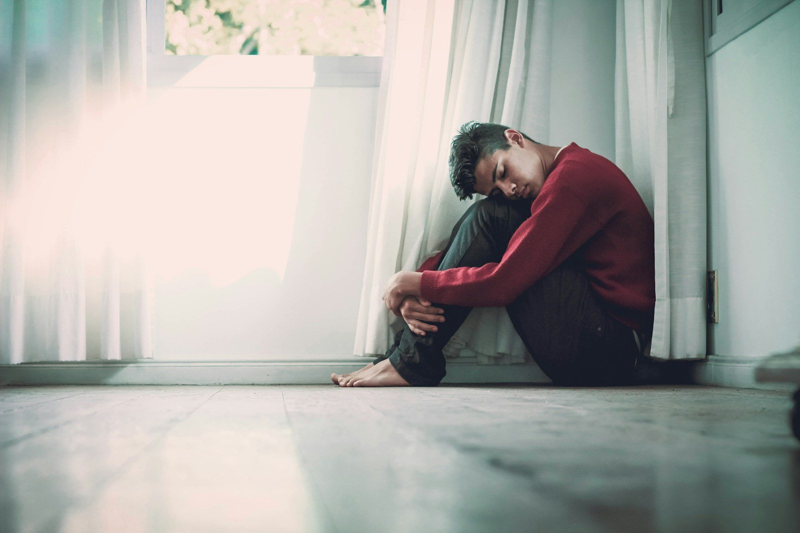 man beside white frame window - what does the bible say about mental illness