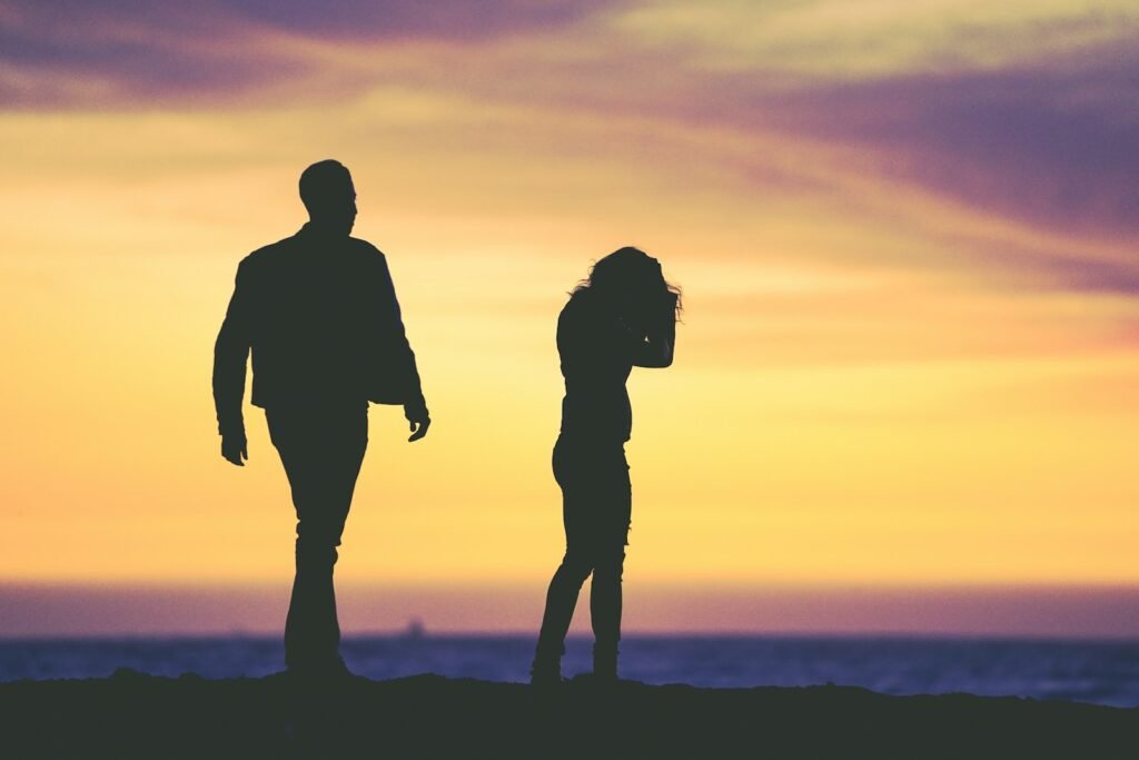 silhouette of man and woman under yellow sky - what does the bible say about infidelity