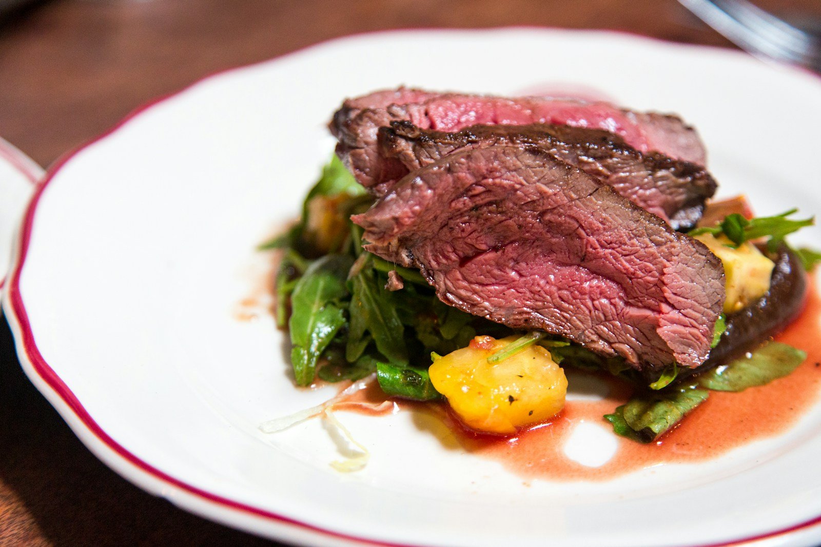 medium rare sliced steak in white ceramic plate - what does the bible say about eating meat