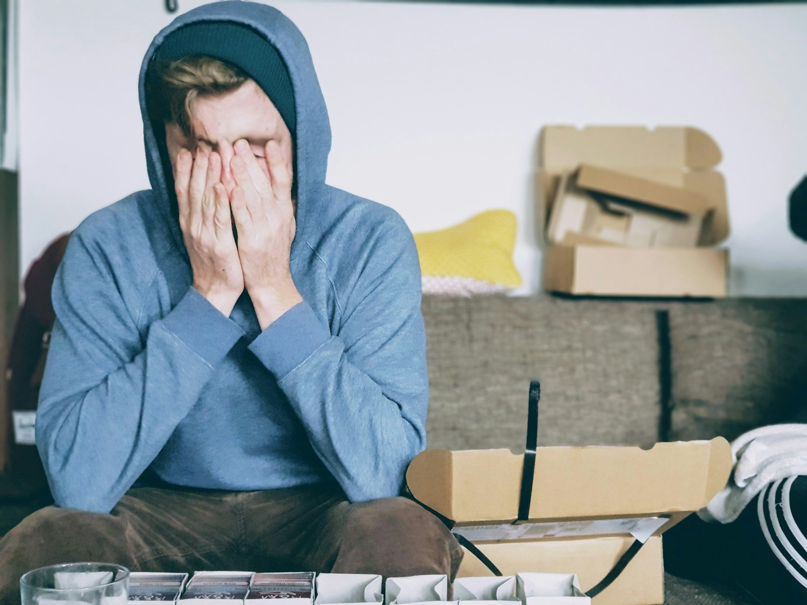 man covering face with both hands while sitting on bench - what does the bible say about stress