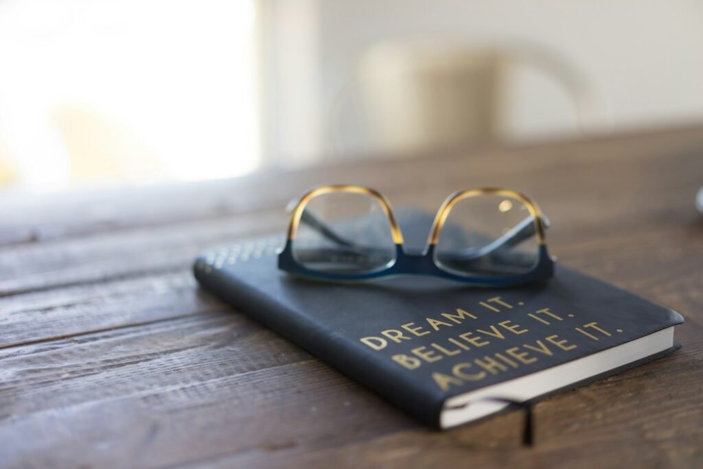 black and brown eyeglasses on book on brown wooden table - what does the bible say about dreams