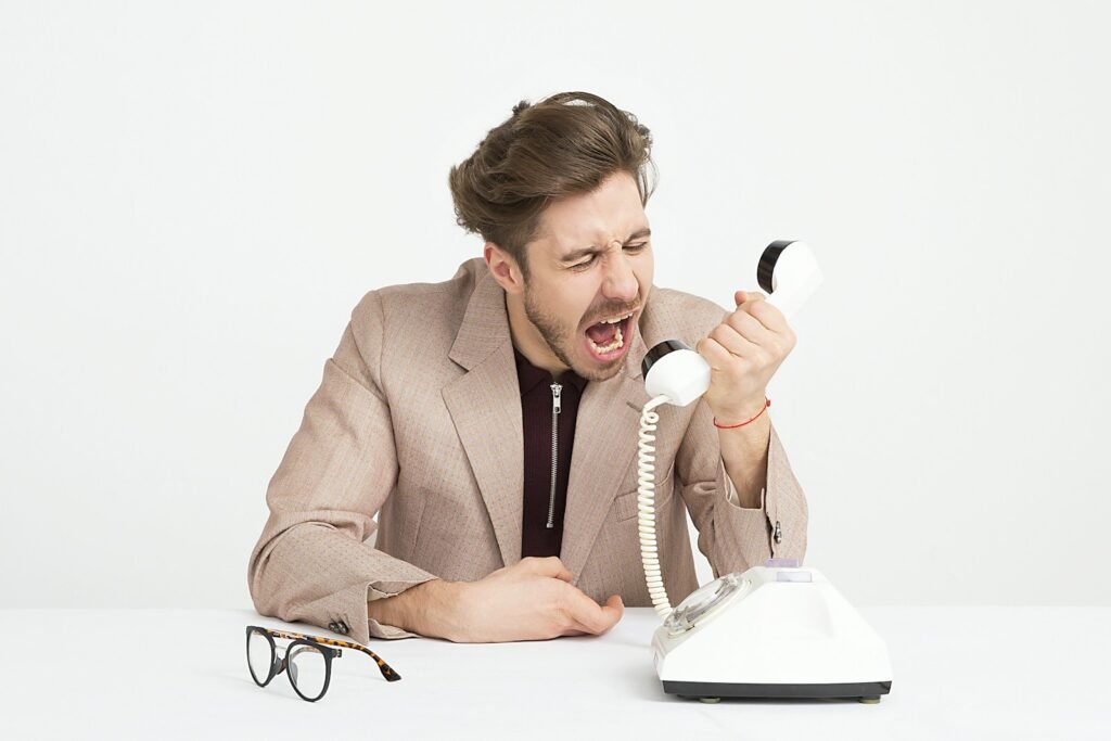 man holding telephone screaming - Can Christians Curse?