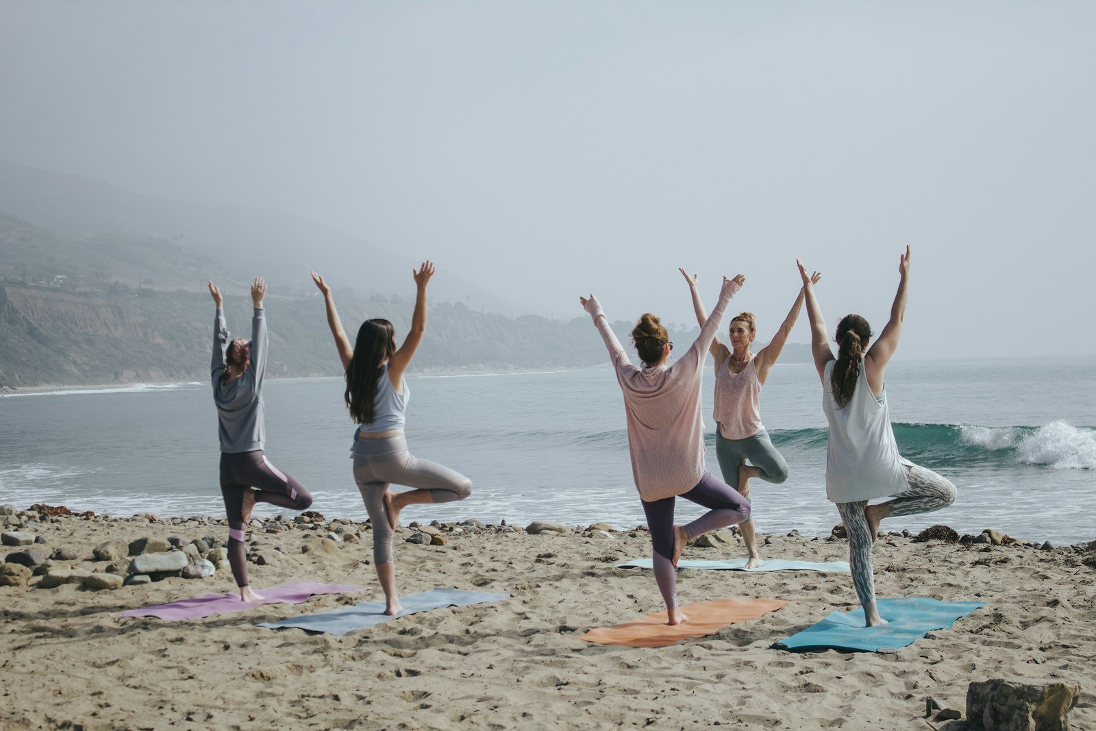 five woman standing on seashore - Can Christians Practice Yoga?